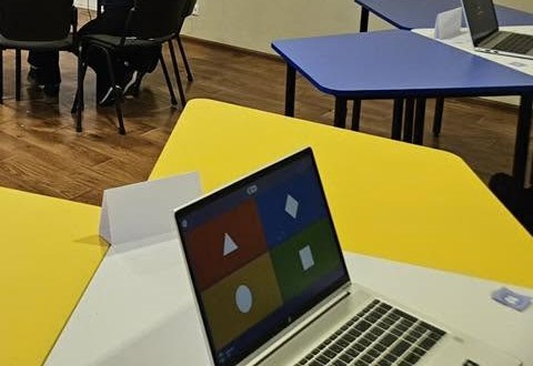 Donated laptop on a classroom desk at Gimnaziul Dumitru Matcovschi, Soroca. Recipient faces are not published.