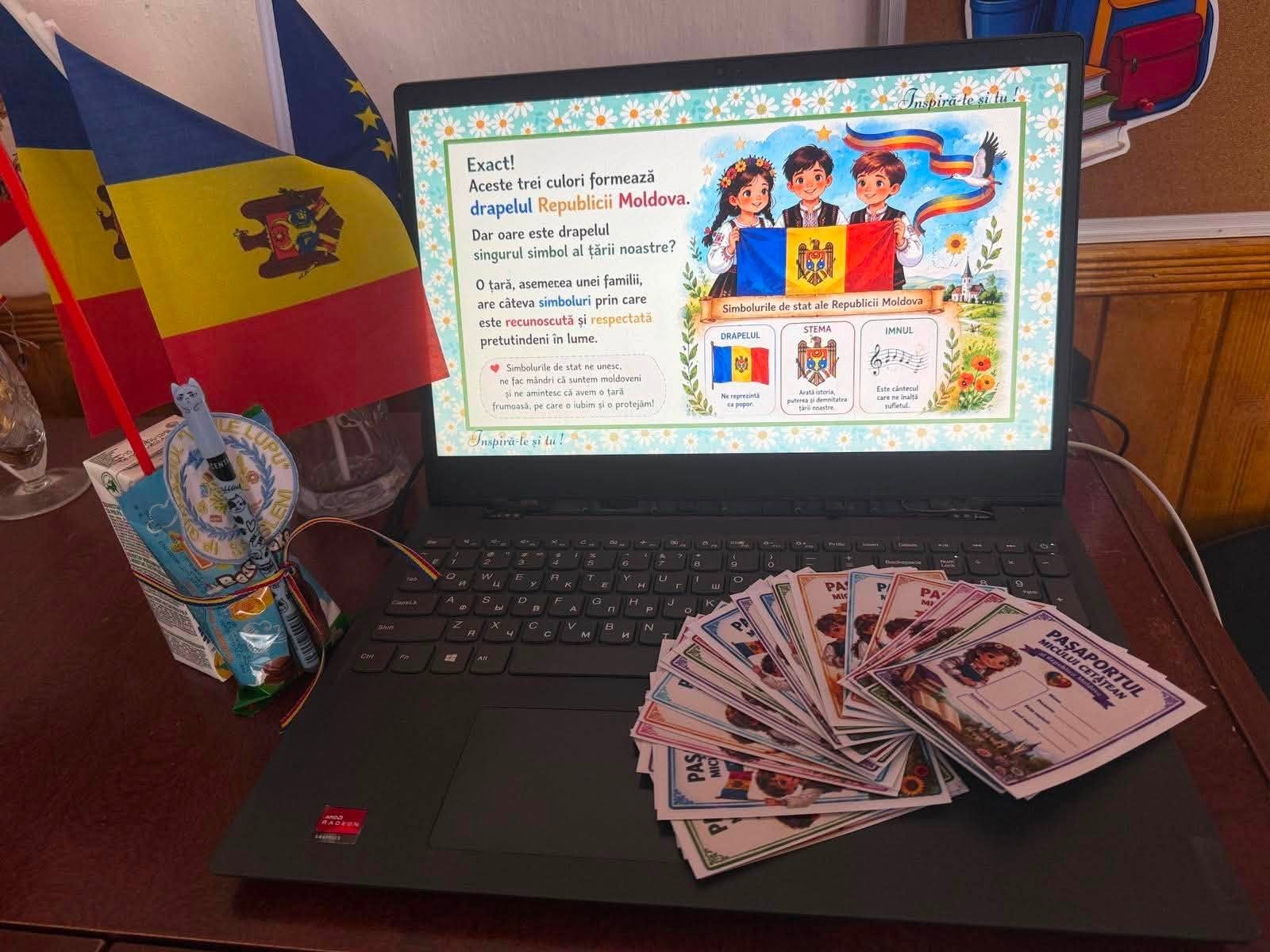 Donated laptop at Gimnaziul Dumitru Matcovschi, Soroca: Moldova civic-education lesson on screen, small flags, citizen-passport cards. Recipient faces are not published.