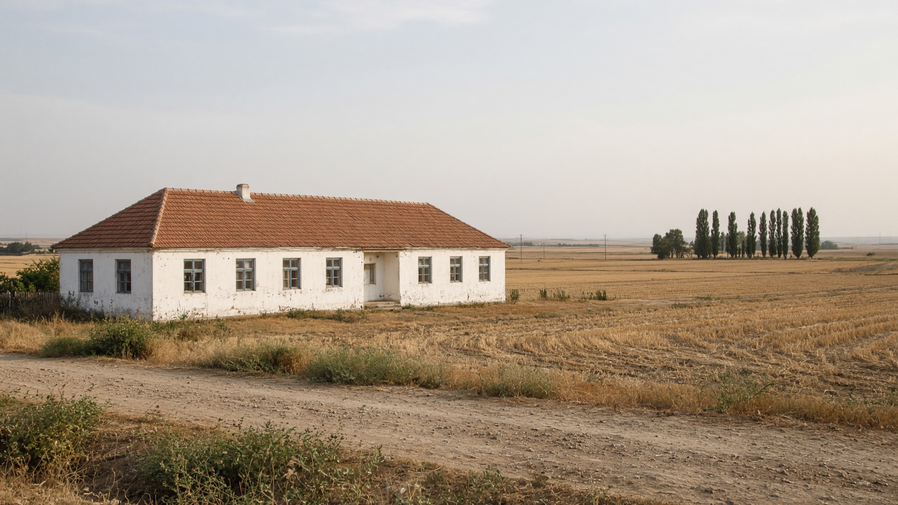 Whitewashed village school on the agricultural plains of Olt County, southern Romania