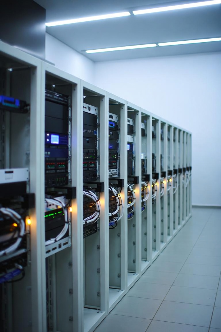 Row of live UK racks — decommissioning happens beside neighbours, not after a site wipe
